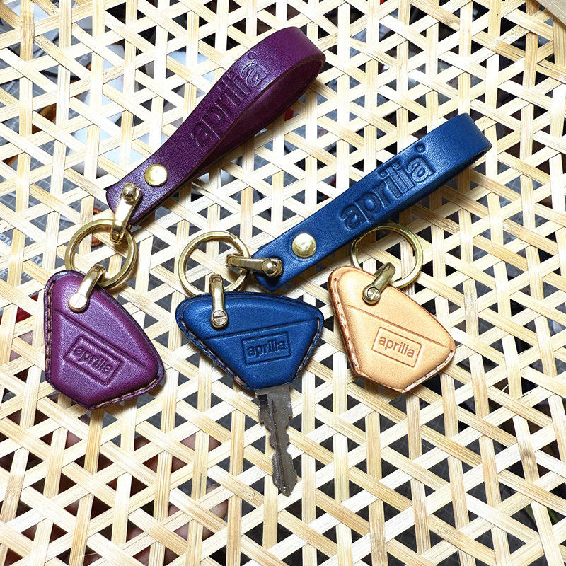 Aprilia RS457 leather key fob cover in purple and blue color options
