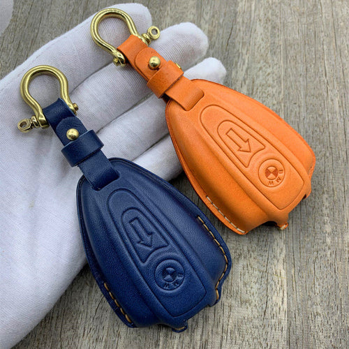 Custom-molded handmade leather key case for BMW R18 in orange and navy with brass S-hook