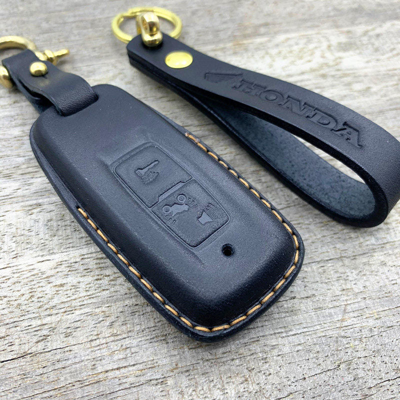 Close-up of vegetable-tanned cowhide stitching on Honda PCX160 smart key case