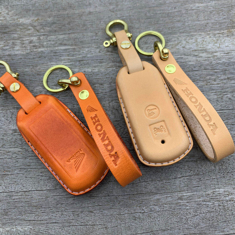 Handmade leather key case for Honda XADV750 and SH300 in orange and natural tan with brass hardware