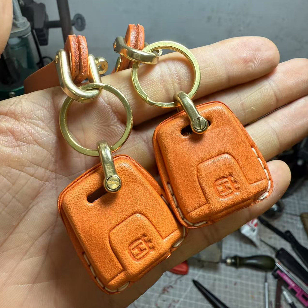 Handmade leather key case for Husqvarna Svartpilen 901 in orange with brass hardware