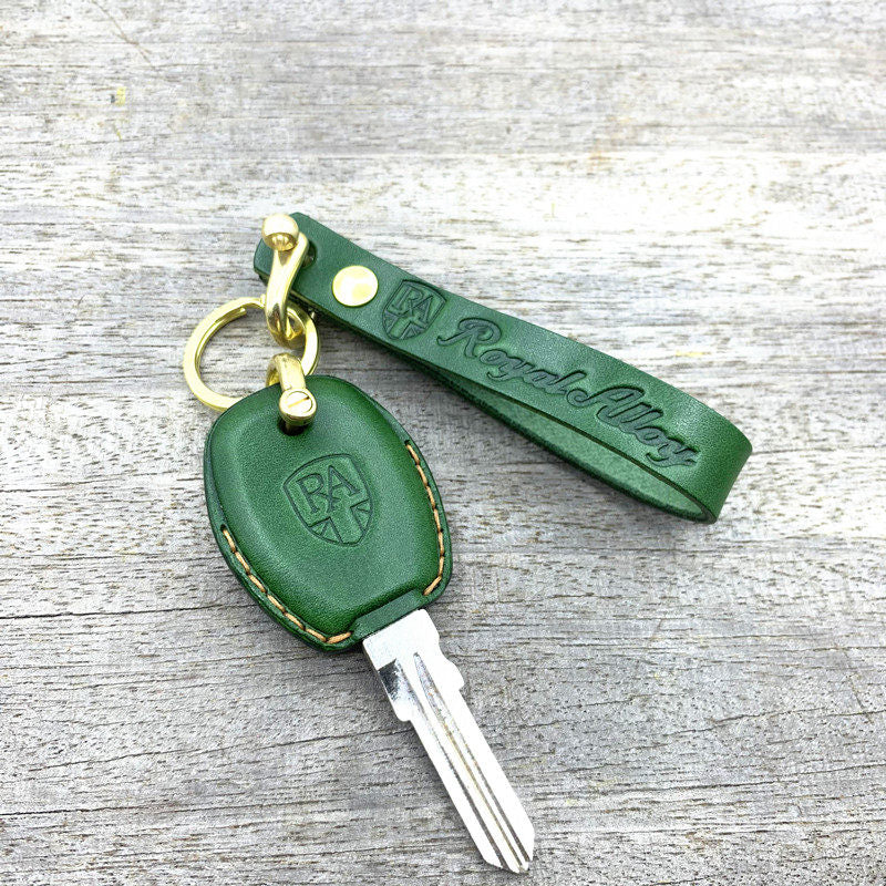 Close-up of embossed Royal Alloy logo and hand stitching on leather key case