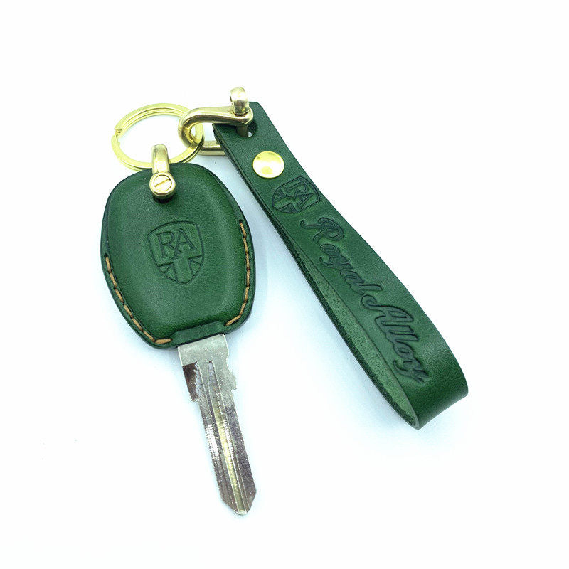 Close-up of embossed Royal Alloy logo and hand stitching on leather key case