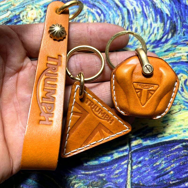 Handmade full-grain leather key case for Triumph motorcycle in tan with brass hardware