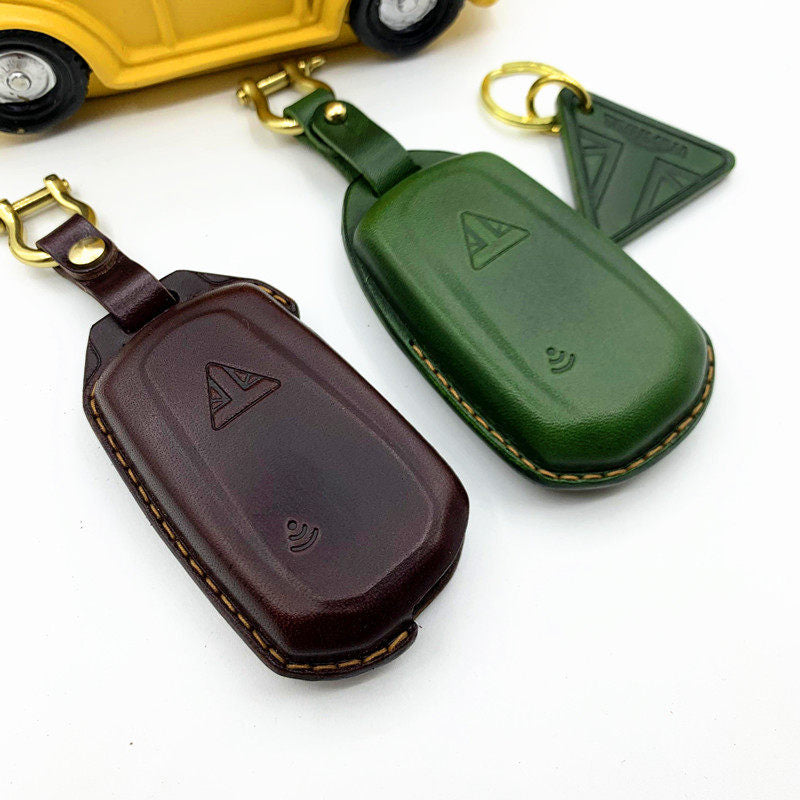 Handmade leather key case for Triumph Scrambler 1200 in dark brown and green with brass hardware